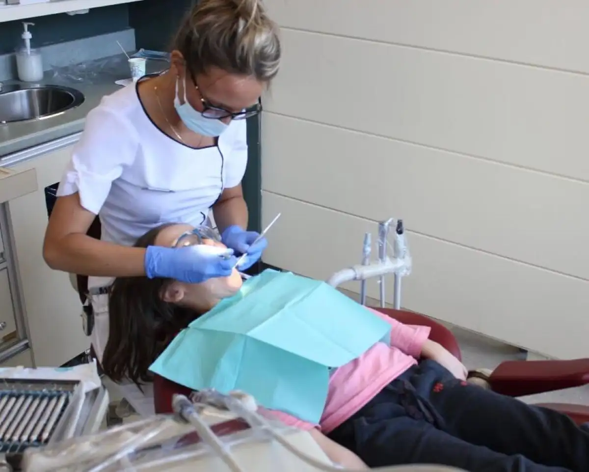 Étudiante qui fait son nettoyage à un enfant