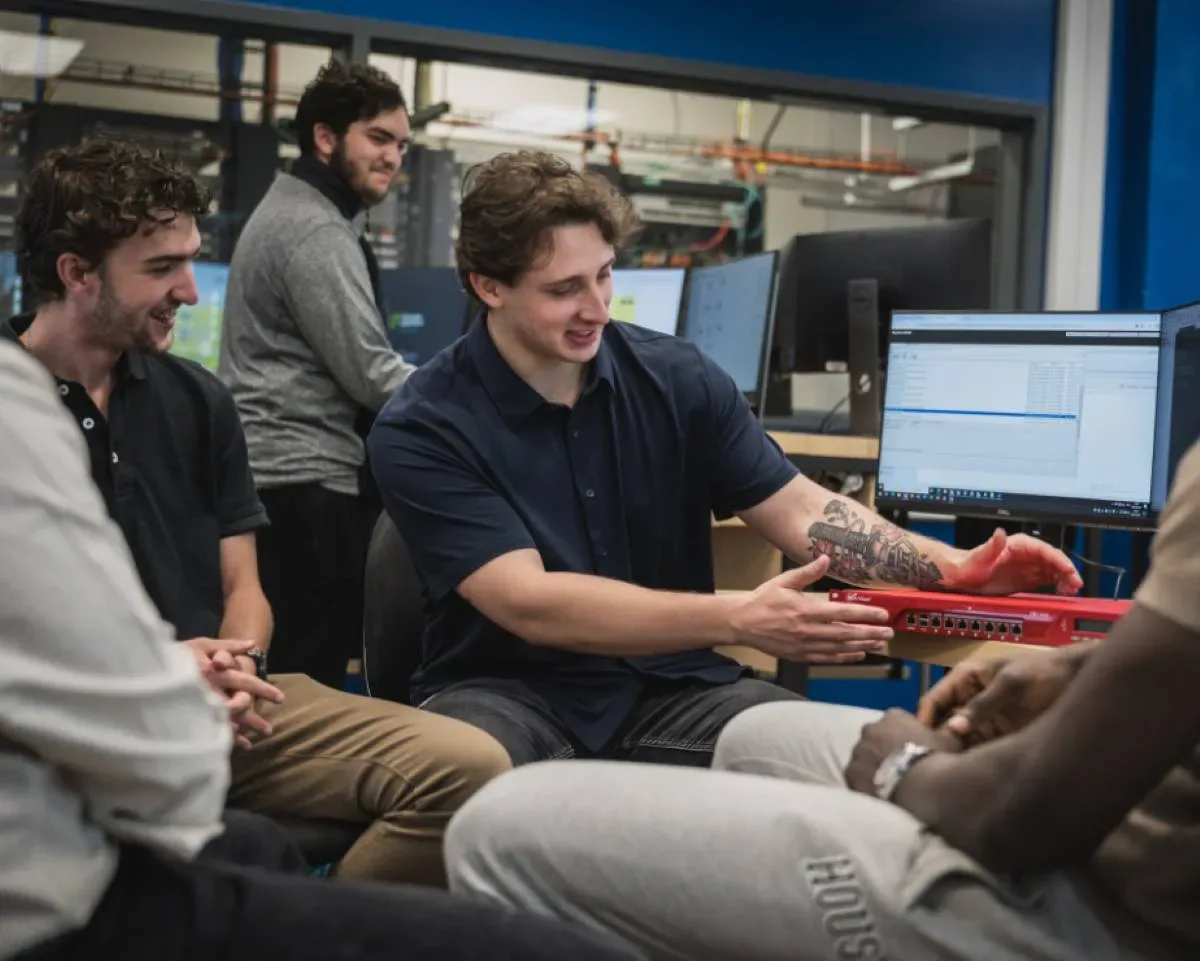 Étudiants qui discutent en salle informatique